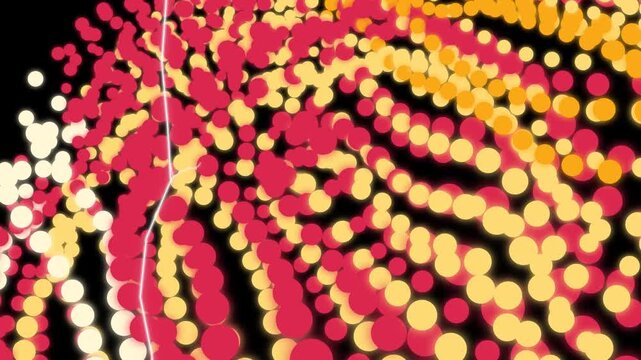 Swirling streams of red and yellow illuminated particles flow dynamically across the dark.