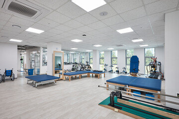 Clean modern hospital or clinic interior with patient beds and medical facility lighting.