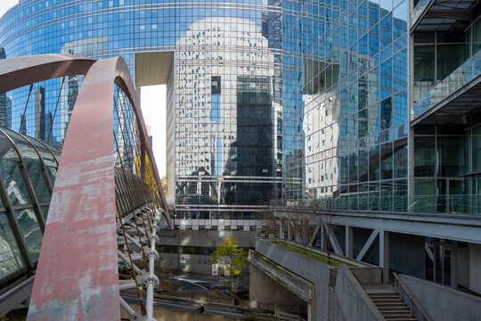 Sculpture landmark in plaza with modern architecture skyline in La Defense Paris business district creating bold contemporary urban scene