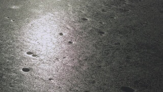 Close up of ice surface with strong sunlight. Moon like texture. Abstract background with natural light.  