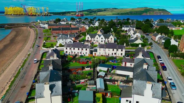 Aerial view of residential coastal homes in Nigg along the Cromarty Firth highlighting peaceful rural lifestyle and Scottish seaside living.