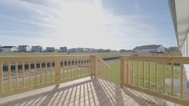 New build house builder grade deck overlooking a new development and cornfield in Iowa