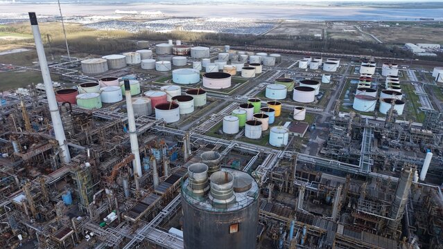 Aerial view of a sprawling industrial complex with a network of pipes and storage tanks, a testament to human engineering against the backdrop of nature, Immingham, United Kingdom.