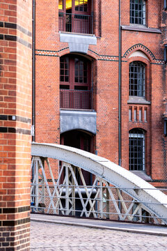 Close view of brick warehouse detail with historic bridge on the waterfront in Hamburg HafenCity Germany highlighting architecture texture and urban heritage