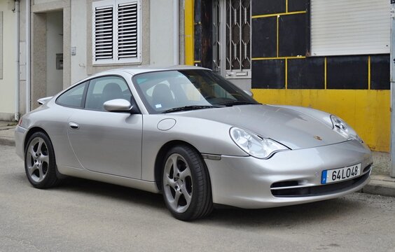 Porsche 911 Carrera 996 silver sports car parked on street