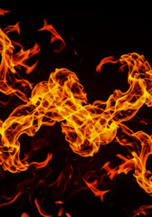 Fototapeta premium Dynamic abstract image of bright orange and yellow fire swirling with intense energy, creating dramatic shapes on a dark backdrop.
