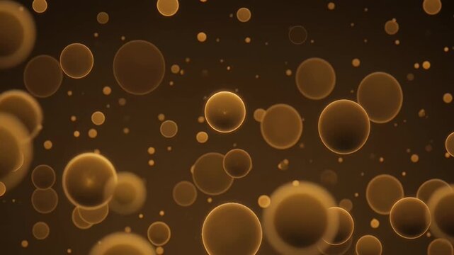 Abstract animation of amber colored bubbles and particles floating in a dark background with soft glowing effects. This visual evokes a sense of movement and organic energy.