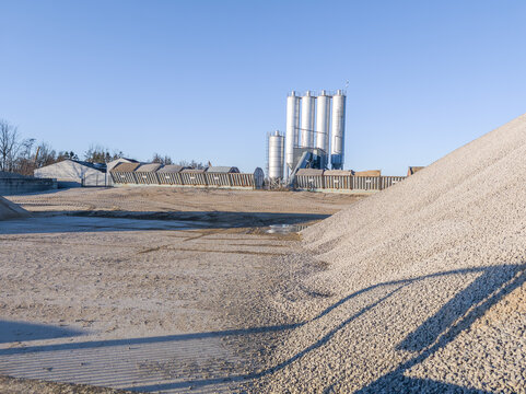 Silo, delivery and bulk storage system at industrial plant for building materials, sand, pebbels for production of concrete. Metal boxes with different kinds of sand. Industrial installation, building