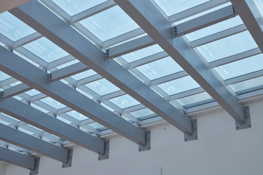 Skylight ceiling with steel beams and glass roof structure in modern building