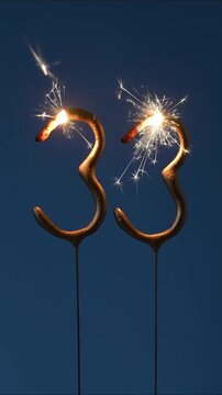 33 years celebration festive background made with Bengal fires in the form of number Thirty three. Vertical video.