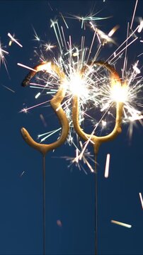 30 years anniversary celebration festive footage made with Bengal fire in the form of number Thirty. Vertical video.