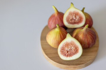 A close-up of ripe fig fruits served on a wooden board.