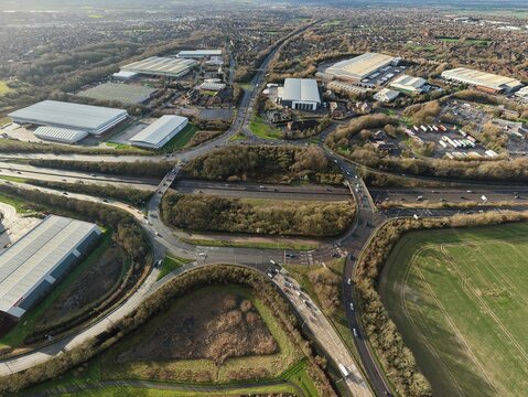 Aerial view of the A5 and M42 interchange creating a symphony of concrete and greenery, near the industrial estates, Tamworth, England, United Kingdom.