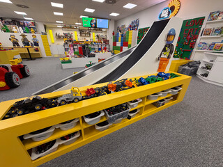 Naklejka premium Colorful lego playroom with slide and toy vehicle display
