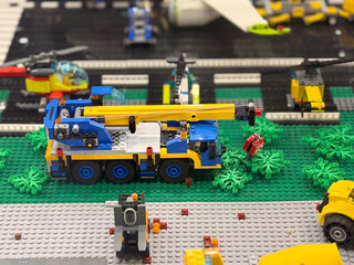 Naklejka premium Lego crane truck lifting red object