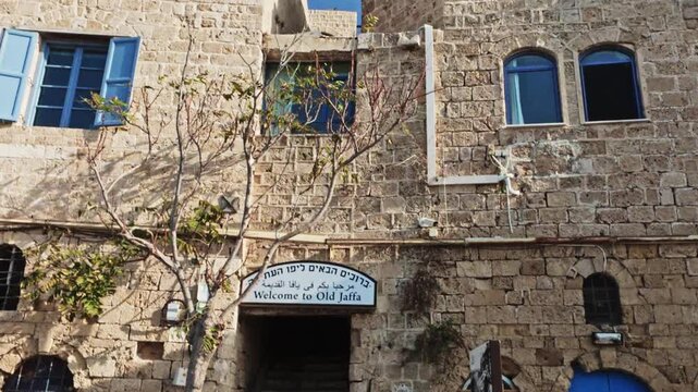 Welcome To Old Jaffa Sign On Ancient Stone Wall Entrance