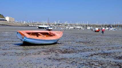 Fototapeta premium Port and beach at low tide at Saint-Cast-le-Guildo, a commune in the Côtes-d'Armor department of Brittany in northwestern France