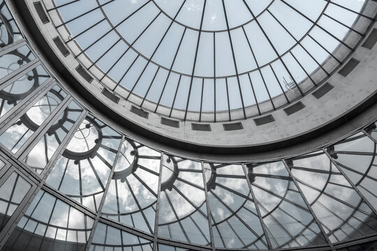 Interior architecture dome with glass ceiling and circular skylight structure showing symmetry pattern and abstract modern design in radial geometry