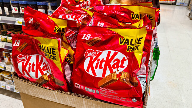 Nestle KitKat chocolate wafer value pack bags displayed in a cardboard box on a retail supermarket shelf in a grocery store on March 4, 2026 in Bangkok, Thailand.