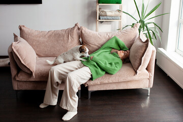 Obraz premium Depressed middle-aged woman resting on home couch, lying on back, looking away, touching head, suffering from headache, migraine, depression, going through loss, grief