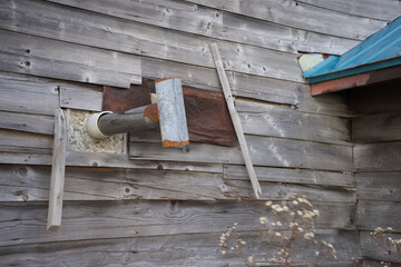 古い木造住宅とトタンの煙突