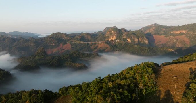 Sunrise Over Ban Ja Bo In The Mae Hong Son Province of Thailand. Sea Of Clouds And Mountainscape. Aerial Wide Shot