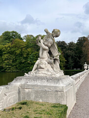 Fototapeta premium A sculpture in Nordkirchen depicting children - putti playing on the shore of the palace moat, North Rhine-Westphalia, Deutschland, Westphalian Versailles
