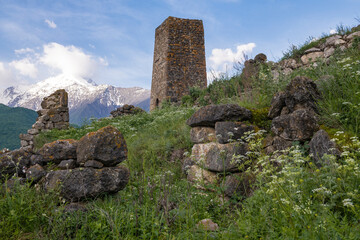 Ancient Ossetian tower in a mountainous summer landscape on a sunny June morning. Tsmiti, North Ossetia-Alania. Russian Federation
