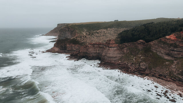 Cliff at the edge of the sea during a cloudy day