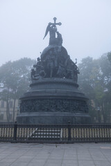 The old Millennium of Russia monument in the fog on an early October morning. The Kremlin of Veliky Novgorod