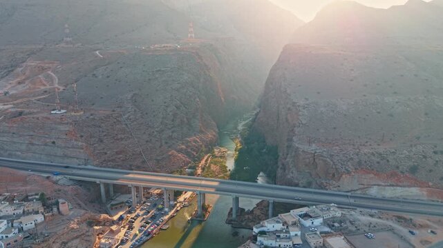 Drone shot over Wadi Shab with turquoise river and mountain gorge