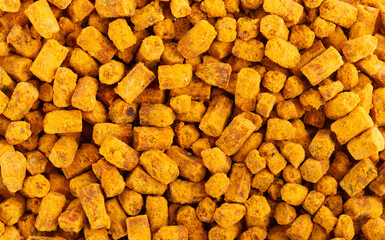 Bee bread background. Pile of granules bee bread or perga. Close-up.