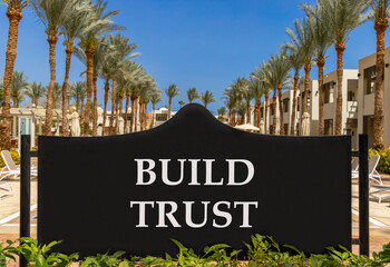 Build trust symbol. Concept words Build trust on beautiful big black road sign. Beautiful blue sky...