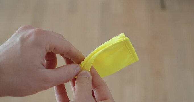 Close-up of a bright yellow first aid armband featuring a green patch with a white medical cross, symbolizing emergency response, health support, and safety awareness.