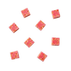 Small cubes of strawberry jelly with seeds on transparent background