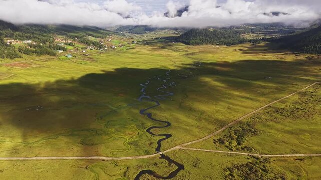 Aerial view of the serene Phobjikha Valley, a landscape bathed in neutral tones, creating a tranquil, ethereal scene from above, Nubding, Bhutan.