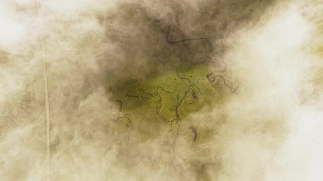 Aerial view of the meandering rivers cutting through the green and brown landscape of the Phobjikha Valley, partially obscured by ethereal clouds, Nubding, Bhutan.