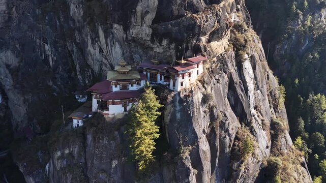 Aerial view of Tiger's Nest Monastery clings to a cliffside, a striking contrast to the rugged mountain, Taktsang, Paro, Bhutan.