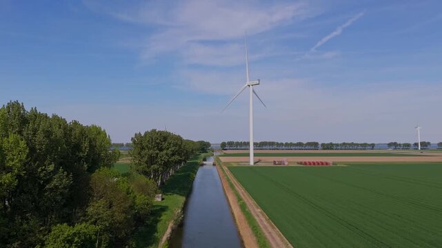 Middelharnis, Netherlands - 28 april 2025: Aerial view of Vattenfall wind turbines, part of Energiepark Haringvliet Zuid, standing tall amidst a patchwork of green and brown fields