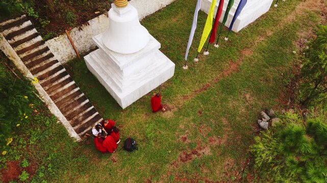 Walakha, Bhutan - 23 September 2025: Aerial view of the Sangchhen Dorji Lhuendrup Lhakhang Nunnery, where white stupas stand on green grass under the open sky.