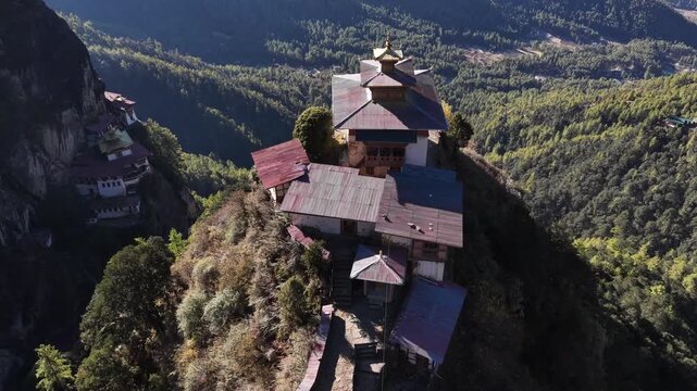 Aerial view of the Tiger's Nest Monastery clings dramatically to a cliffside, a spectacle of architectural ingenuity and spiritual devotion, Taktsang, Paro, Bhutan.