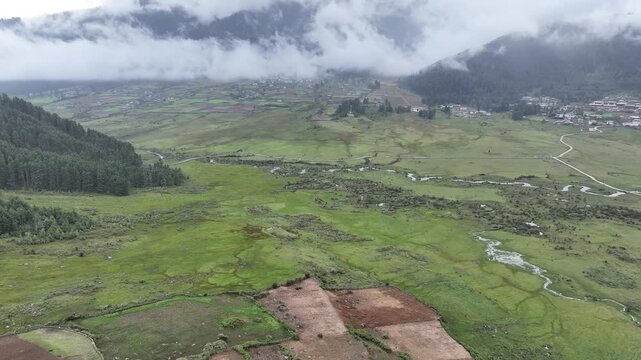 Aerial view of Phobjikha Valley, a vast U-shaped glacial valley with a meandering river and scattered settlements, Wangdue Phodrang, Bhutan.