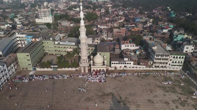 Aerial view of Katra Masjid surrounded by buildings and people gathered in the courtyard, Malda, West Bengal, India.
