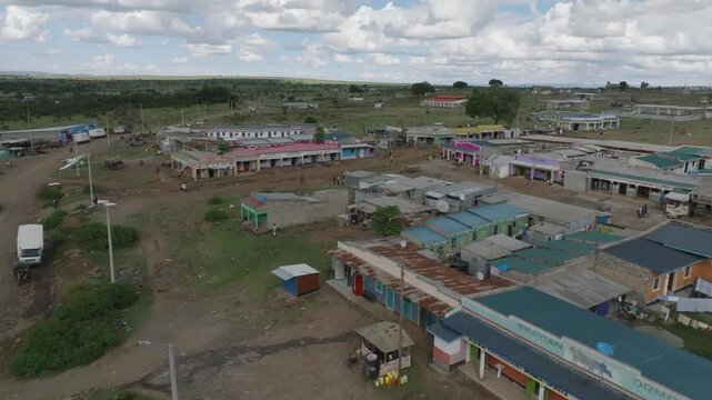 Aerial view of buildings with colorful roofs creating a textured scene against the backdrop of the open landscape, Narok, Narok, Kenya.