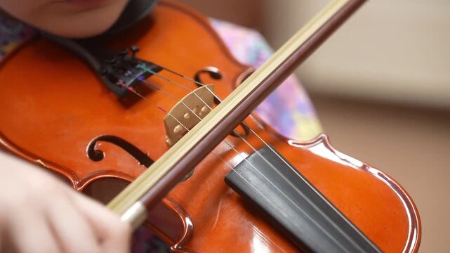 The Girl plays and trains the violin at a music school. A child's violin lesson. High quality video