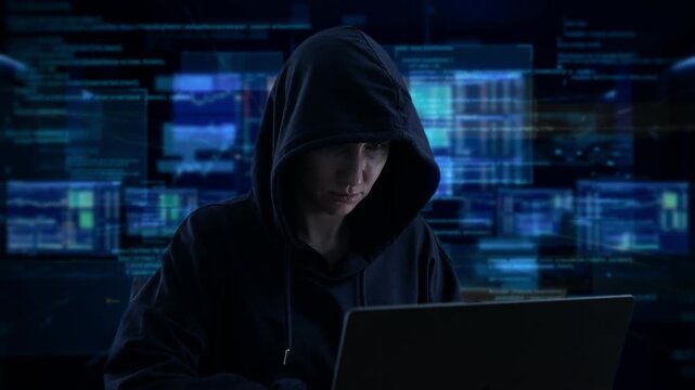 Focused Hacker Research. Hooded Young Man Focused On Researching System Vulnerabilities Late Into Night