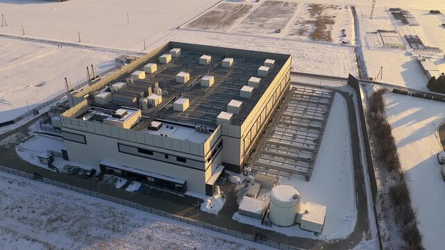 Aerial view of a modern data center and its infrastructure during a winter sunset, Warszawa, Wojewodztwo mazowieckie, Poland.