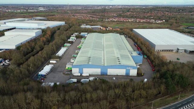 Northampton, United Kingdom - 14 February 2026: Aerial view of Morrisons distribution centre, surrounded by trees and other industrial buildings.