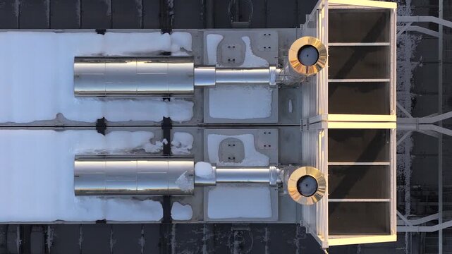 Aerial view of Modern industrial ventilation system on a data center's roof covered in snow, Warszawa, Poland.