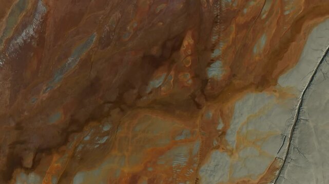 Aerial view of the landscape showing striking contrasts between rust-colored earth and grey tones, Minas de Riotinto, Andalusia, Spain.